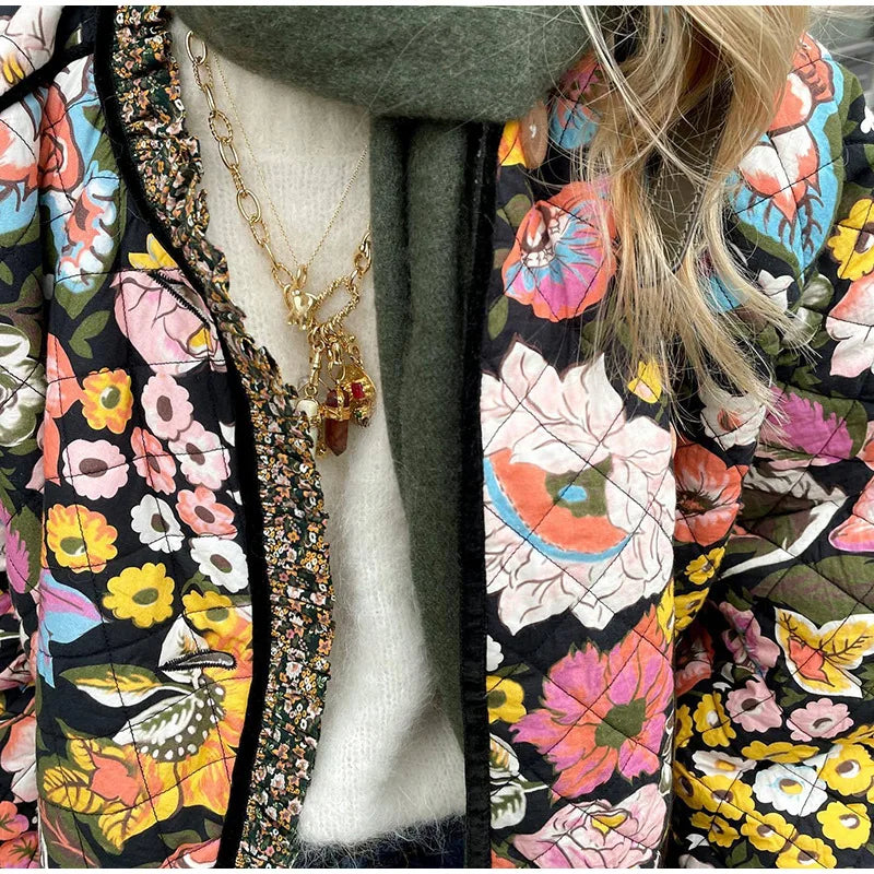 Colorful floral-patterned jacket with a necklace on a mannequin