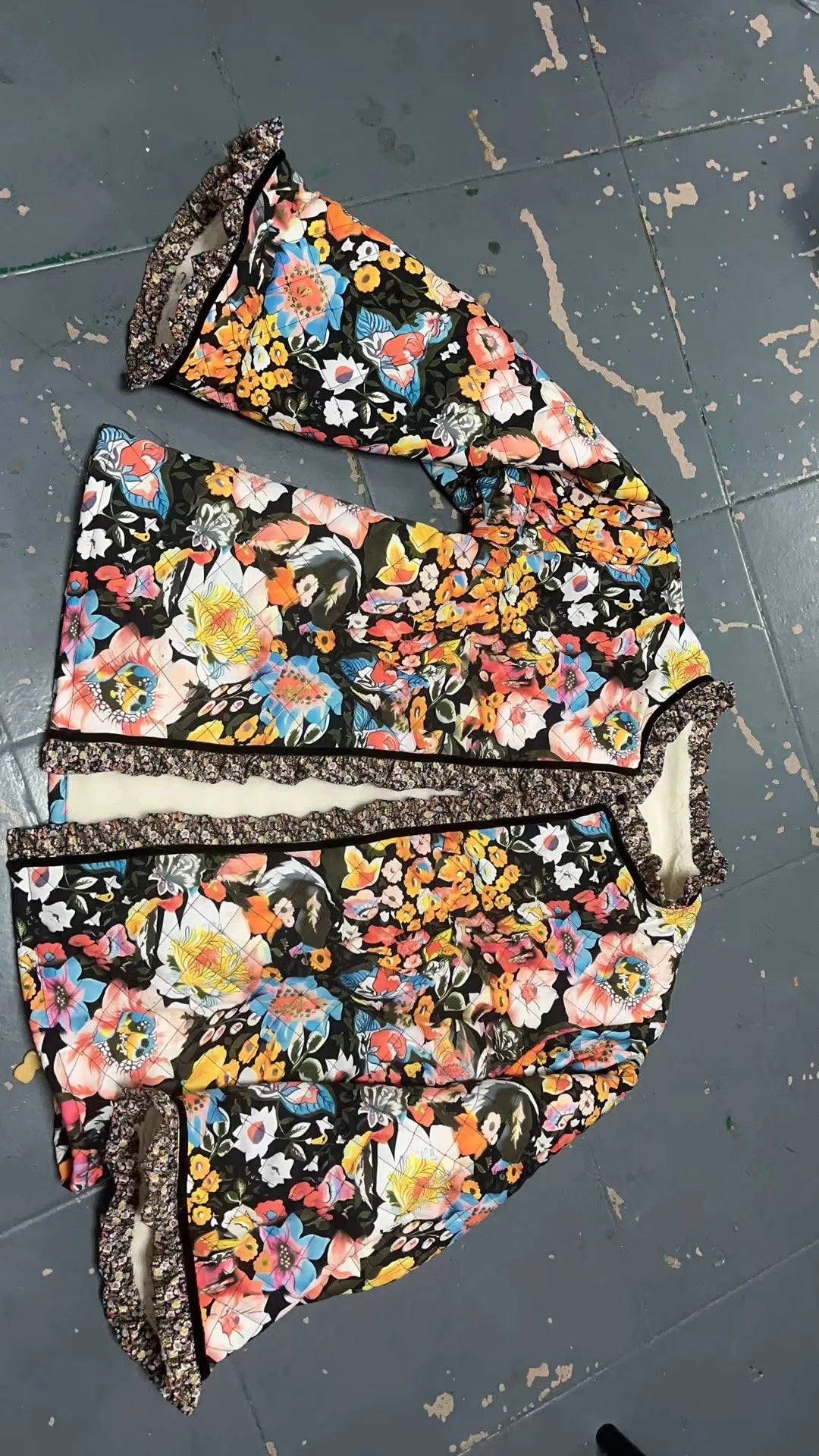 Floral patterned fabric pieces on a dark surface