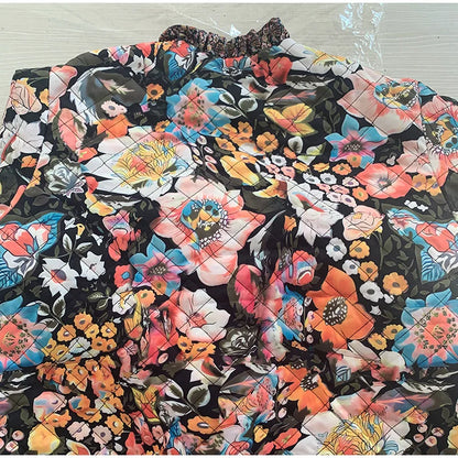 Floral quilt with colorful patterns on a wooden surface