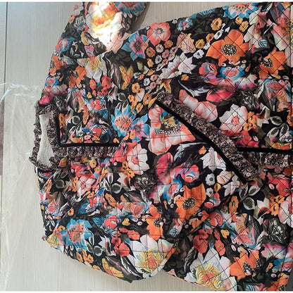 Floral patterned bag on a light wooden surface