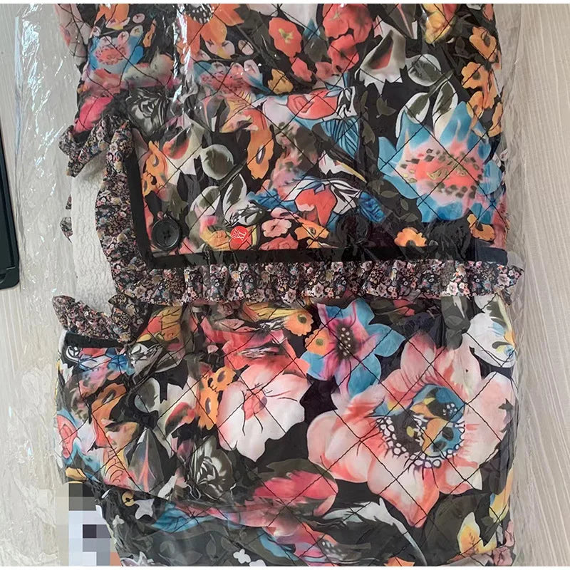 Floral-patterned quilt with colorful flowers on a plain background