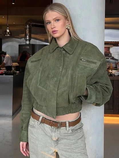Woman wearing a green jacket in an indoor setting