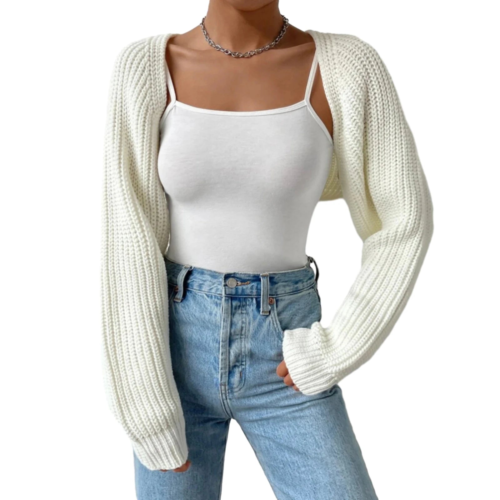 Person wearing a white knit cardigan, white tank top, and blue jeans on a white background